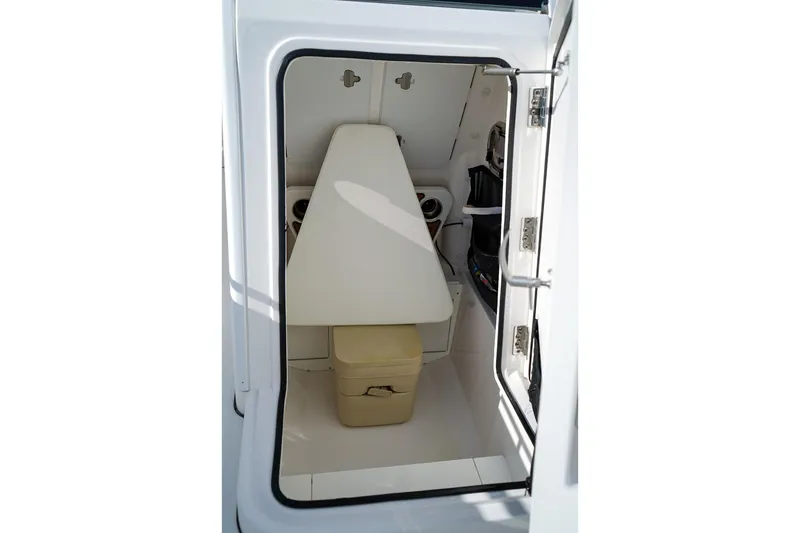 Slide: The Image of 2021 Edgewater 230CC boat interior cabin with seating and storage. - 14