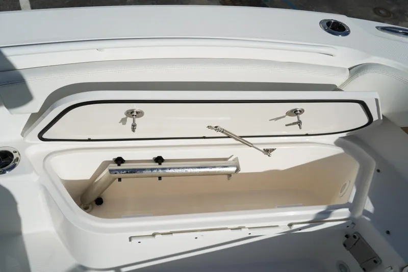 Slide: The Image of Open storage compartment on 2021 Edgewater 230CC boat, featuring secure latches and sleek design. - 20