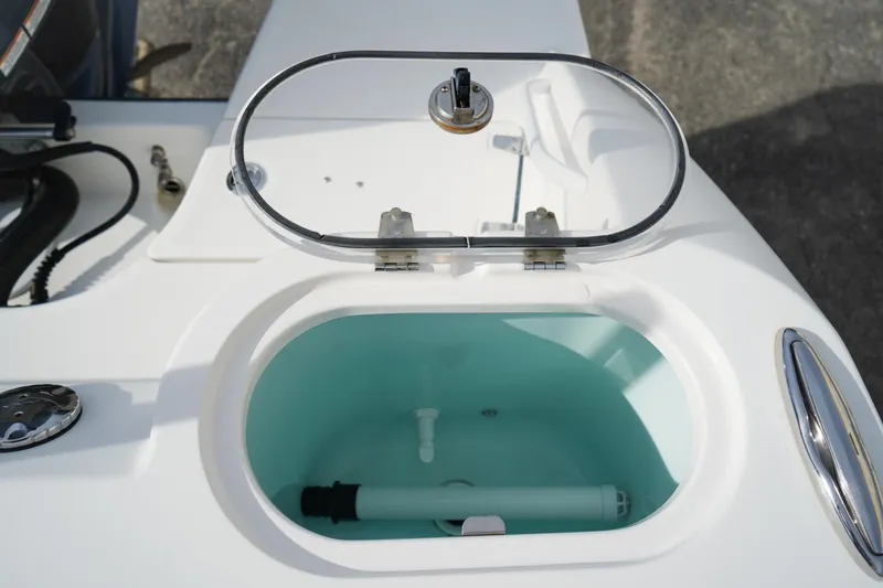 Slide: The Image of Open hatch on 2021 Edgewater 230CC boat, revealing storage compartment. - 6