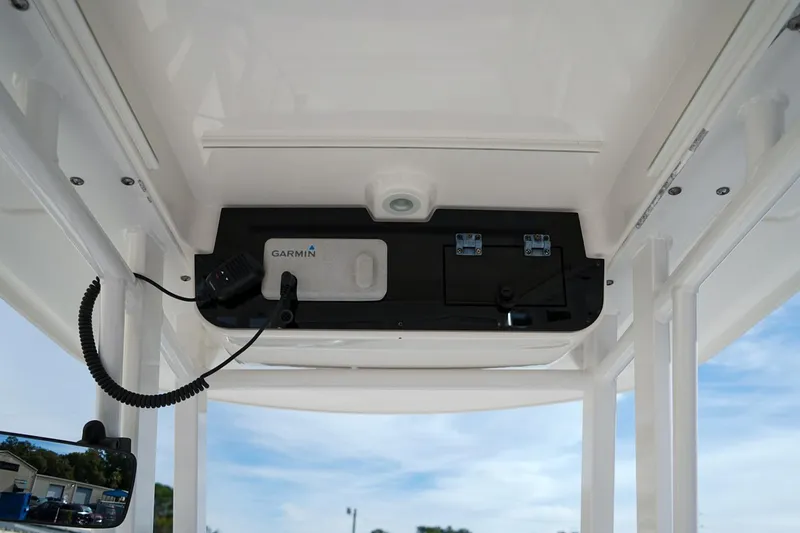 Slide: The Image of 2021 Edgewater 230CC boat console with Garmin equipment and clear sky background. - 8