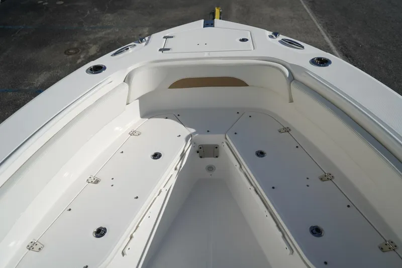 Slide: The Image of 2021 Edgewater 230CC boat interior, featuring spacious seating and storage compartments. - 9