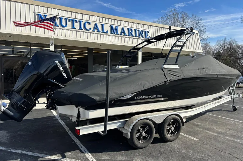 Slide: The Image of 2022 Chaparral 23 SSi OB boat with cover, parked at Nautical Marine dealership. - 12