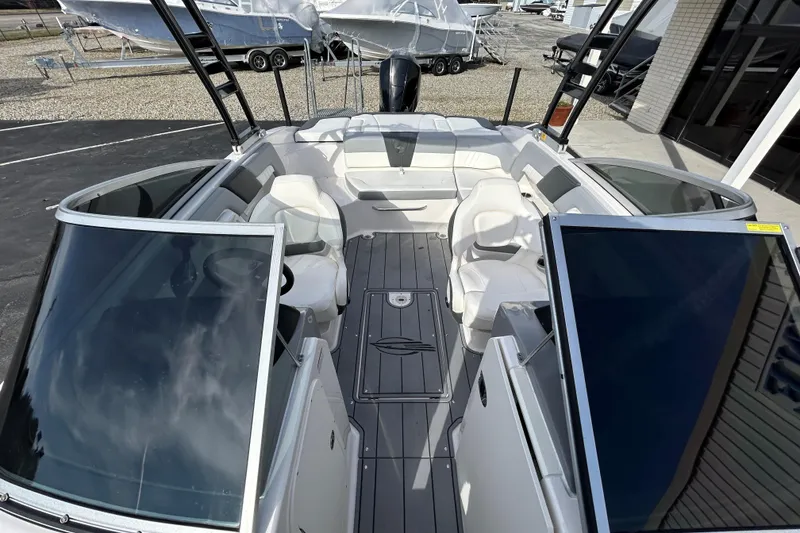 Slide: The Image of 2022 Chaparral 23 SSi OB boat interior with white seating and sleek design. - 13