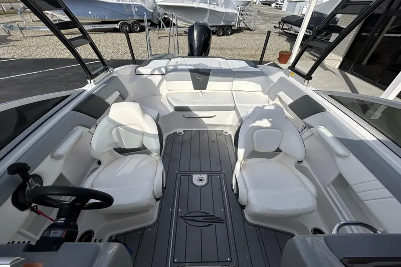 Slide: The Image of 2022 Chaparral 23 SSi OB boat interior with white seating and modern design. - 14