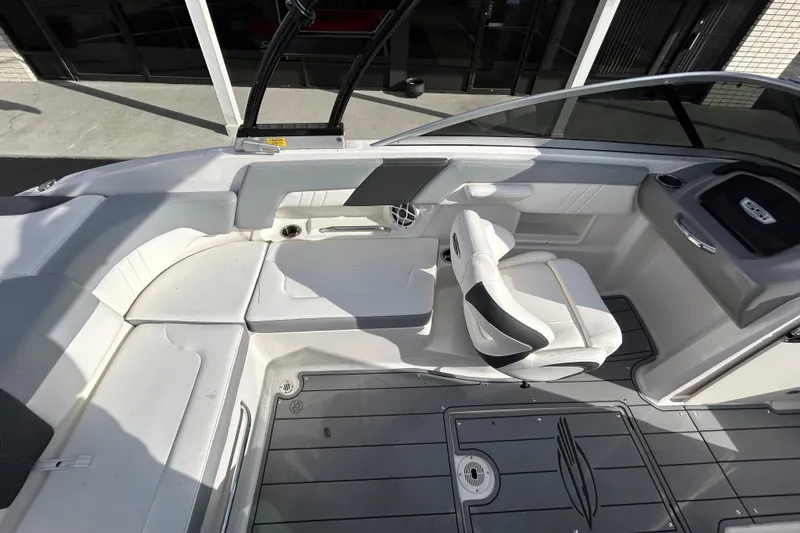 Slide: The Image of 2022 Chaparral 23 SSi OB boat interior with white seating and sleek design. - 15