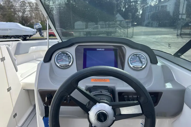 Slide: The Image of 2022 Chaparral 23 SSi OB boat dashboard with steering wheel and gauges. - 17