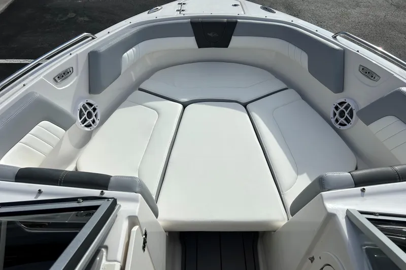Slide: The Image of 2022 Chaparral 23 SSi OB boat interior with white cushioned seating and speakers. - 18