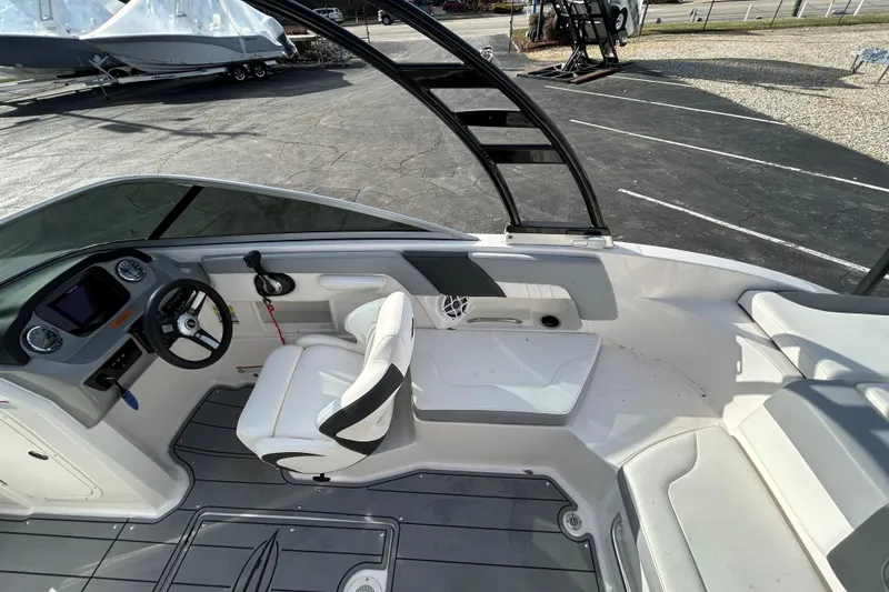 Slide: The Image of 2022 Chaparral 23 SSi OB boat interior with steering wheel and seating area. - 19