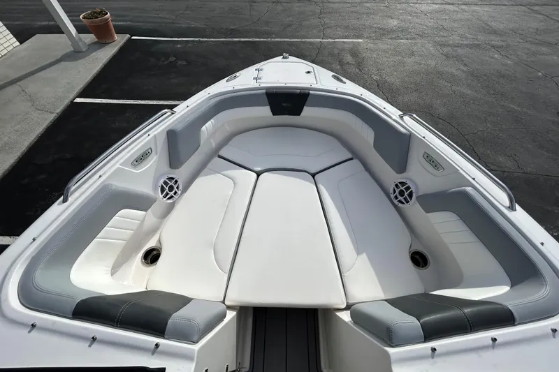 Slide: The Image of 2022 Chaparral 23 SSi OB boat interior with white cushioned seating. - 21