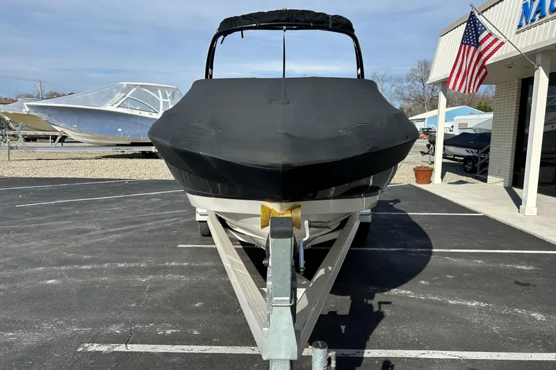 Slide: The Image of 2022 Chaparral 23 SSi OB boat on trailer, covered, in parking lot near dealership. - 8