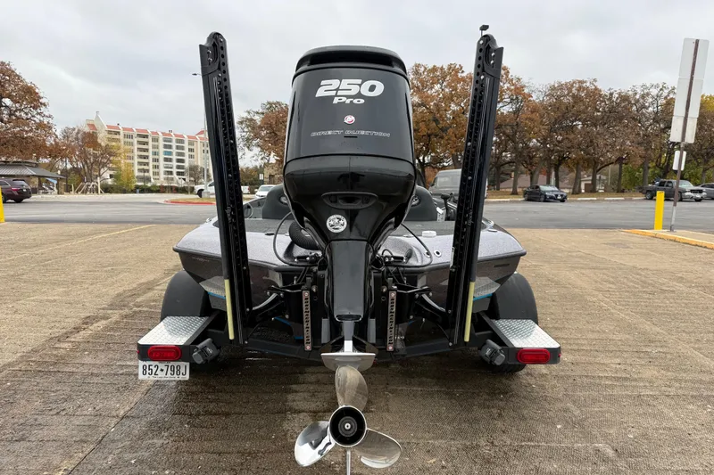 Slide: The Image of 2018 Blazer 625 Pro Elite boat with Mercury engine at a lakeside dock. - 12