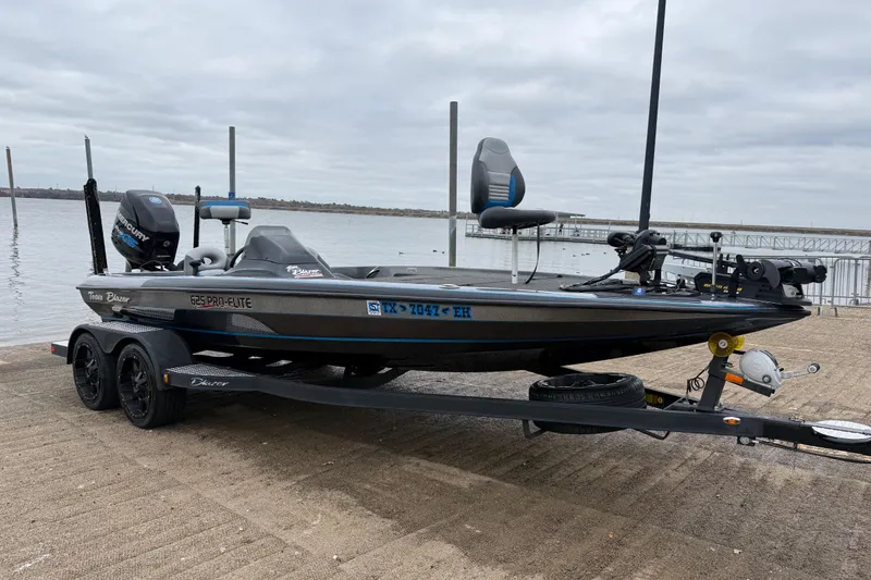 Slide: The Image of Mercury Pro XS outboard motor on 2018 Blazer 625 Pro Elite boat by the water. - 18