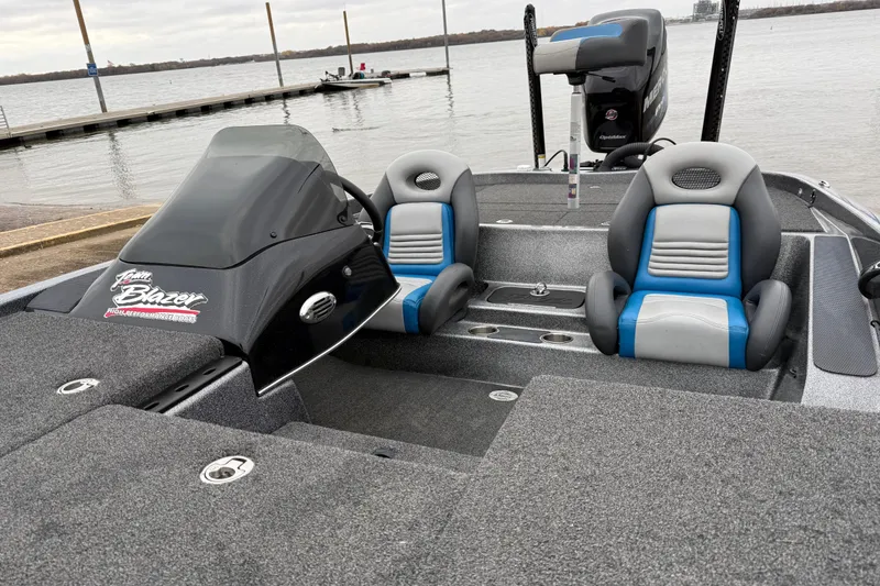 Slide: The Image of 2018 Blazer 625 Pro Elite boat with dual seats, docked by a lake. - 24