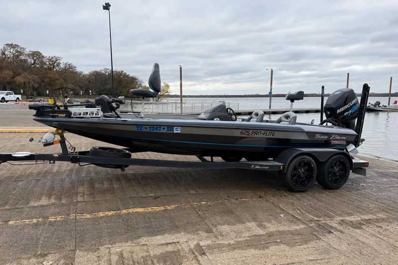 Slide: The Image of 2018 Blazer 625 Pro Elite boat with Mercury Pro XS engine at a lakeside dock. - 3