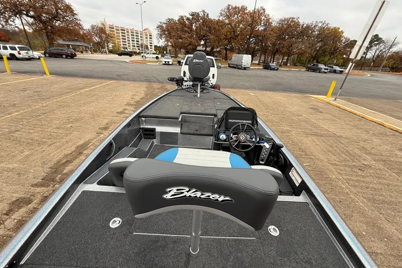 Slide: The Image of 2018 Blazer 625 Pro Elite boat interior with steering console in parking lot. - 32