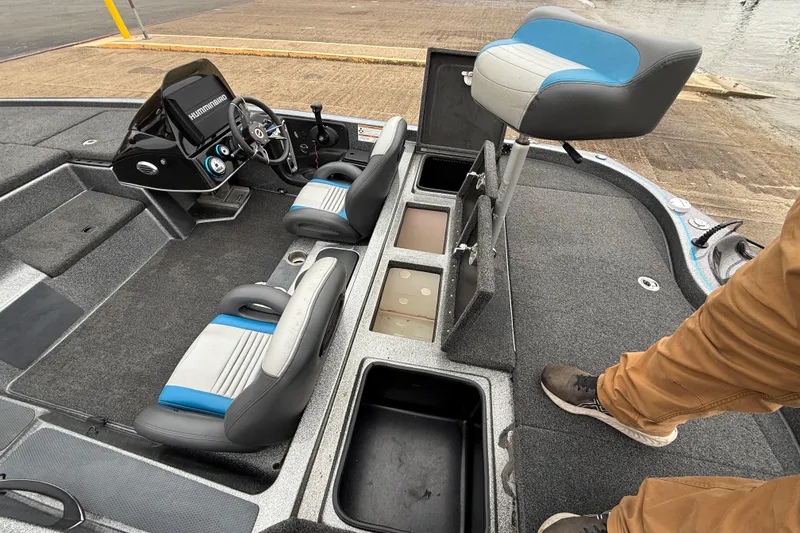 Slide: The Image of 2018 Blazer 625 Pro Elite boat interior with seats, storage compartments, and steering console. - 33