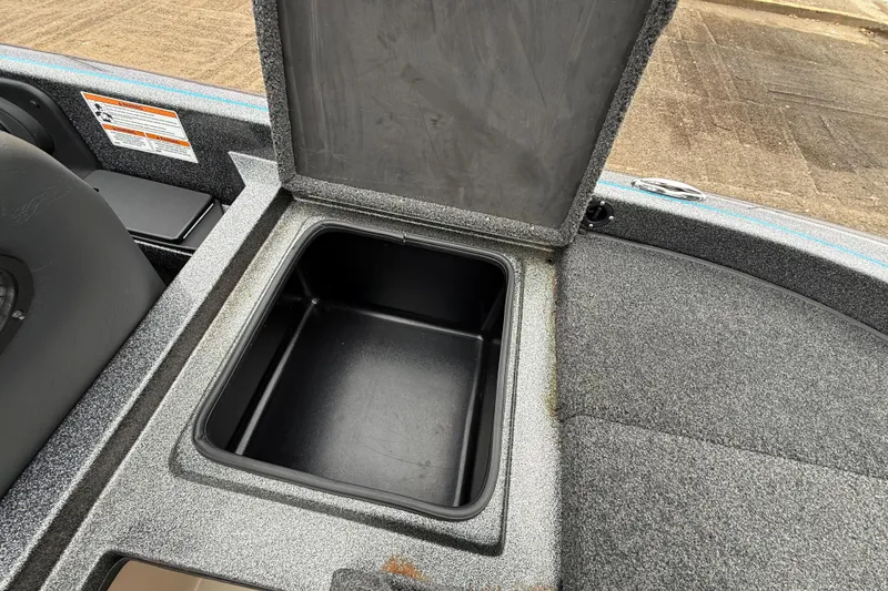 Slide: The Image of Open storage compartment in 2018 Blazer 625 Pro Elite boat, featuring textured interior. - 35