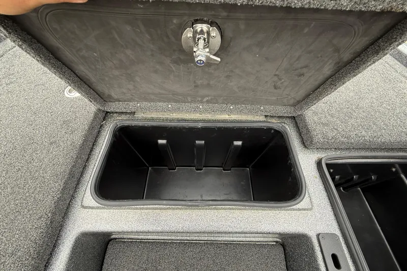 Slide: The Image of Open storage compartment in 2018 Blazer 625 Pro Elite boat, featuring secure latch. - 41