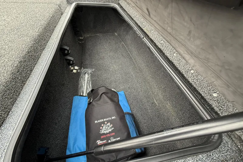 Slide: The Image of Storage compartment of 2018 Blazer 625 Pro Elite boat with branded bag inside. - 43