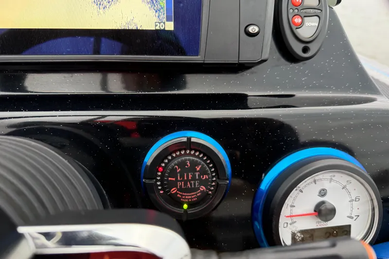 Slide: The Image of Dashboard of a 2018 Blazer 625 Pro Elite boat with lift plate and RPM gauge. - 53