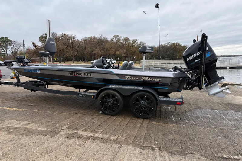 Slide: The Image of 2018 Blazer 625 Pro Elite boat on trailer by lakeside dock. - 6