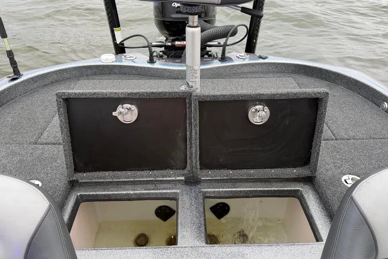 Slide: The Image of 2018 Blazer 625 Pro Elite boat with open storage compartments on the water. - 63