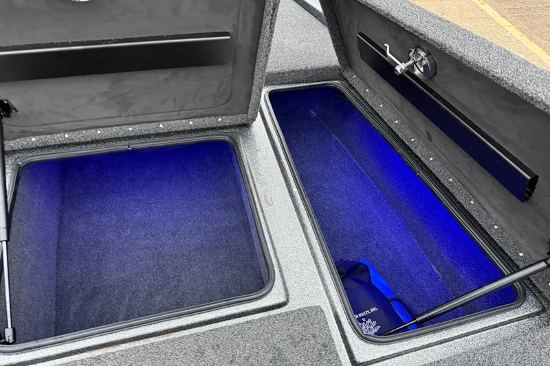 Slide: The Image of Open storage compartments in a 2018 Blazer 625 Pro Elite boat with blue interior lighting. - 66