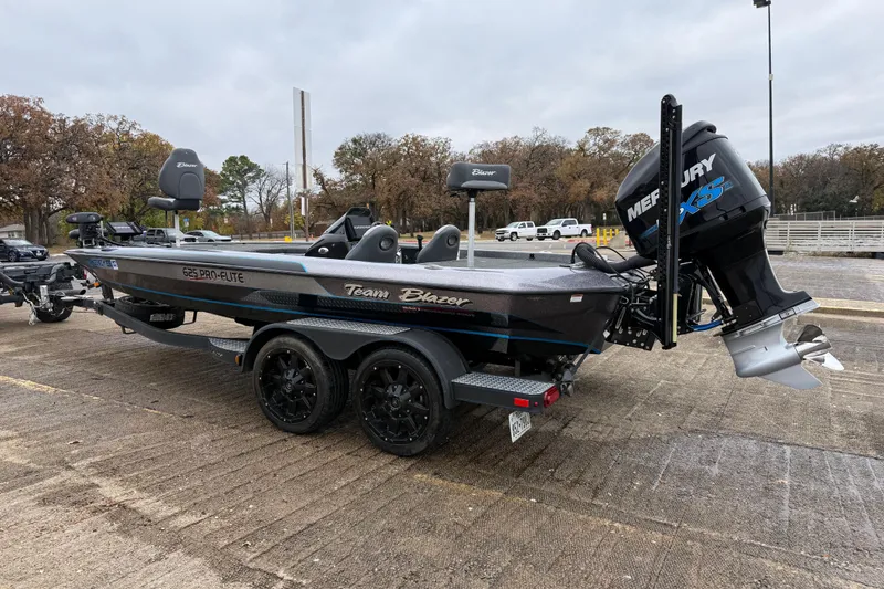 Slide: The Image of 2018 Blazer 625 Pro Elite boat on trailer by a lake under cloudy skies. - 7