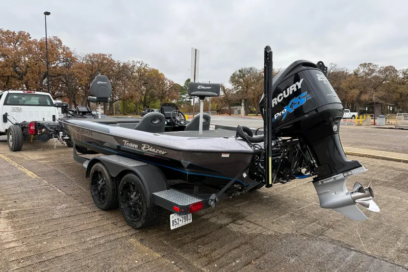 Slide: The Image of 2018 Blazer 625 Pro Elite boat on trailer by lakeside dock. - 8
