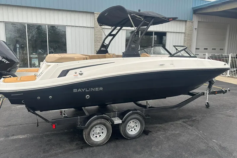 The Image of 2025 Bayliner VR6 Bowrider OB on trailer, sleek design, black and white exterior. - 0