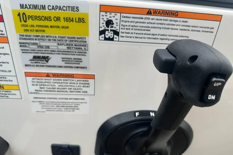 Slide: The Image of Control panel of 2025 Bayliner VR6 Bowrider OB with capacity and safety warnings. - 10