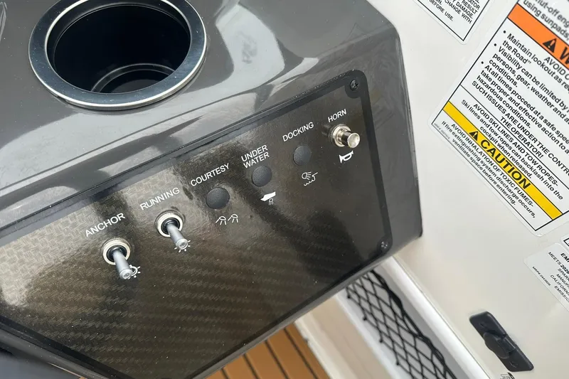Slide: The Image of Control panel of 2025 Bayliner VR6 Bowrider OB with switches and caution labels. - 14