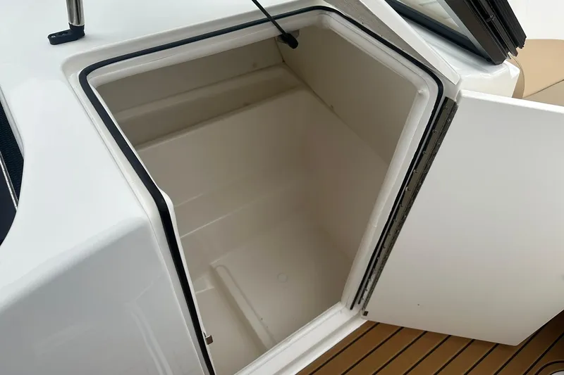 Slide: The Image of 2025 Bayliner VR6 Bowrider OB storage compartment, open on deck. - 20