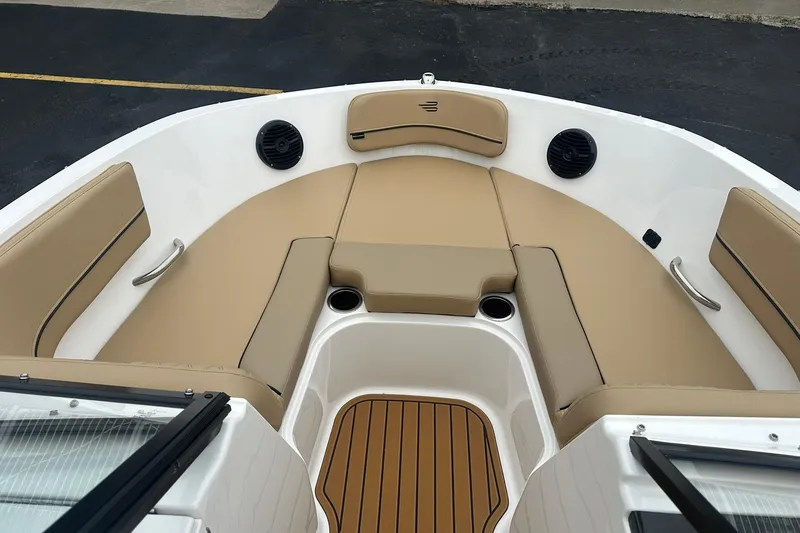 Slide: The Image of 2025 Bayliner VR6 Bowrider OB interior with tan seating and cup holders. - 21