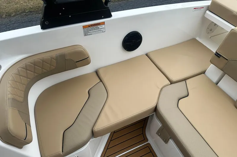 Slide: The Image of 2025 Bayliner VR6 Bowrider OB interior with tan cushioned seating and speaker. - 22