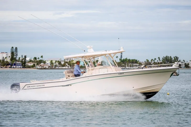 The Image of 2014 Grady-White Canyon 336 boat cruising on water, side view. - 0