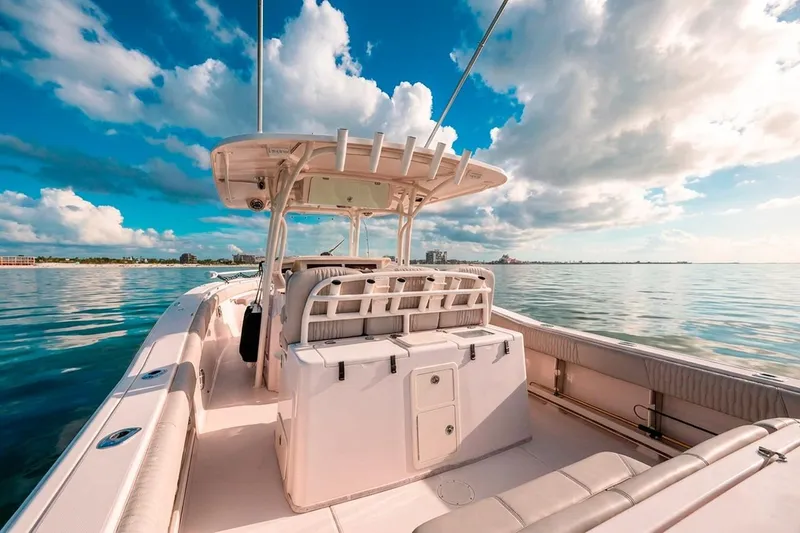 Slide: The Image of 2014 Grady-White Canyon 336 boat on calm water under a vibrant sky. - 13