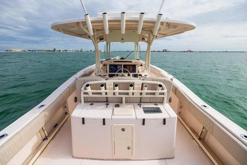 Slide: The Image of 2014 Grady-White Canyon 336 boat on open water, showcasing helm and seating area. - 14