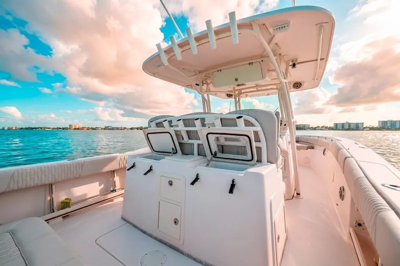 Slide: The Image of 2014 Grady-White Canyon 336 boat on calm water under a vibrant sky. - 15