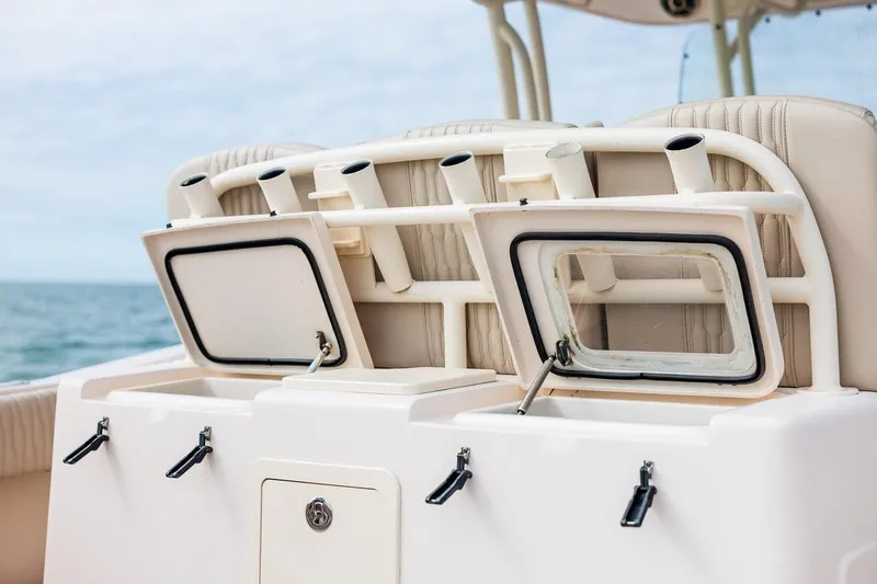 Slide: The Image of 2014 Grady-White Canyon 336 boat with open storage compartments and rod holders. - 16