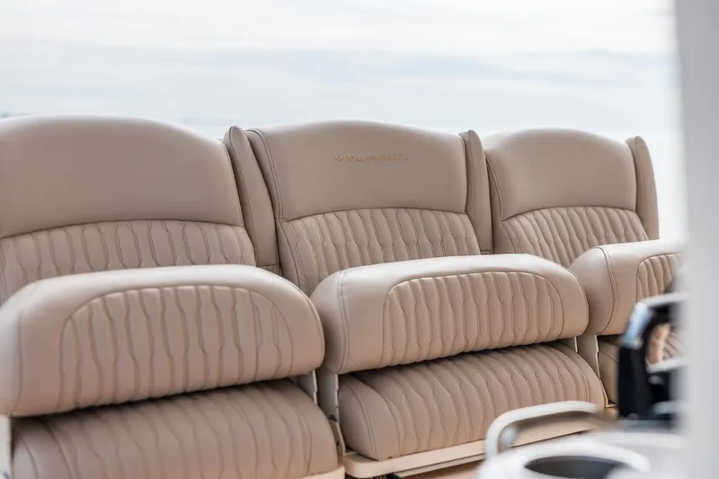 Slide: The Image of Luxurious seating on 2014 Grady-White Canyon 336 boat, featuring plush beige upholstery. - 19