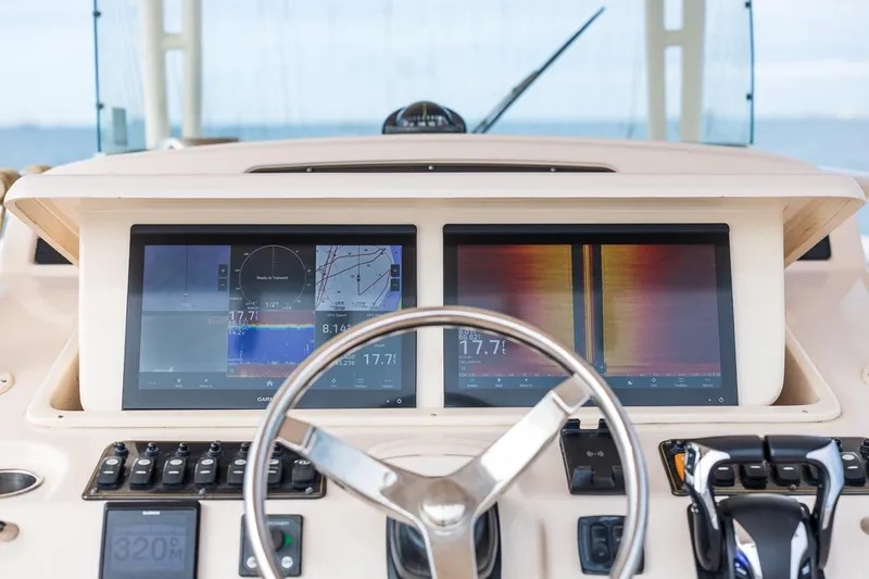 Slide: The Image of Helm of 2014 Grady-White Canyon 336 with dual navigation screens and controls. - 22