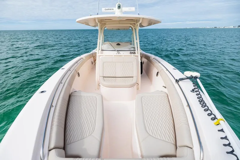 Slide: The Image of 2014 Grady-White Canyon 336 boat on open water, featuring spacious seating and Garmin equipment. - 30