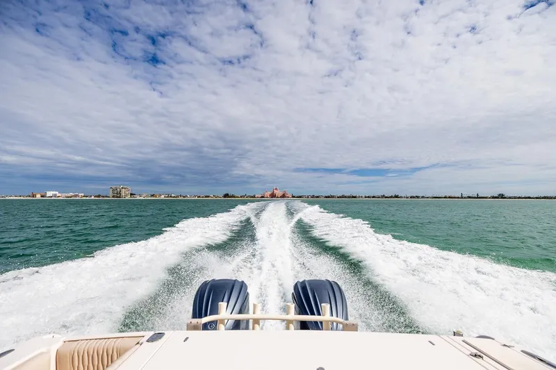 Slide: The Image of 2014 Grady-White Canyon 336 cruising on open water under a cloudy sky. - 39