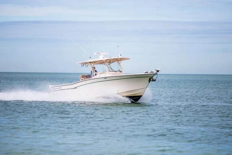 Slide: The Image of 2014 Grady-White Canyon 336 boat cruising on open water. - 44