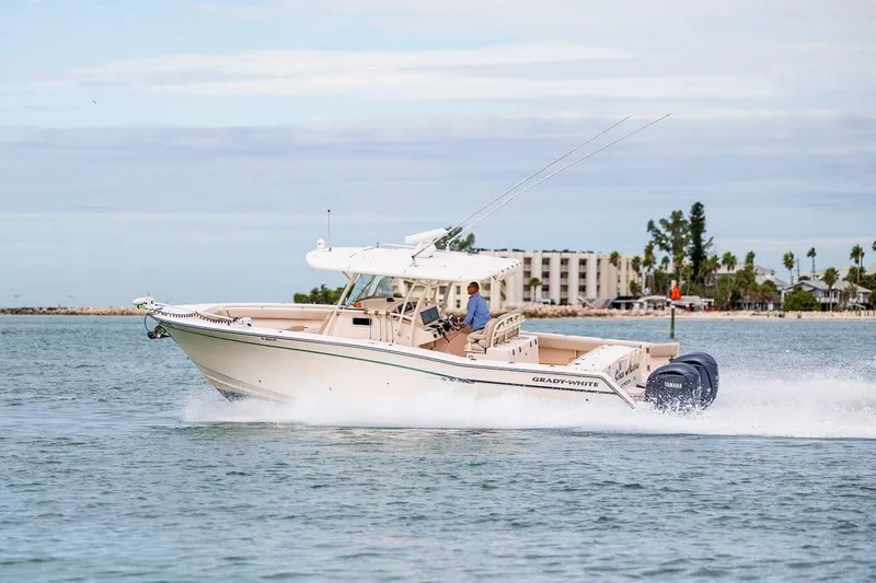 Slide: The Image of 2014 Grady-White Canyon 336 boat cruising on water with scenic background. - 45