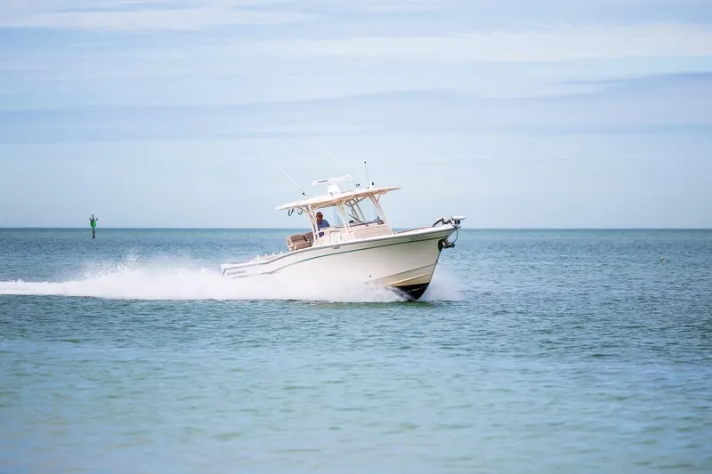 Slide: The Image of 2014 Grady-White Canyon 336 boat cruising on open water. - 53