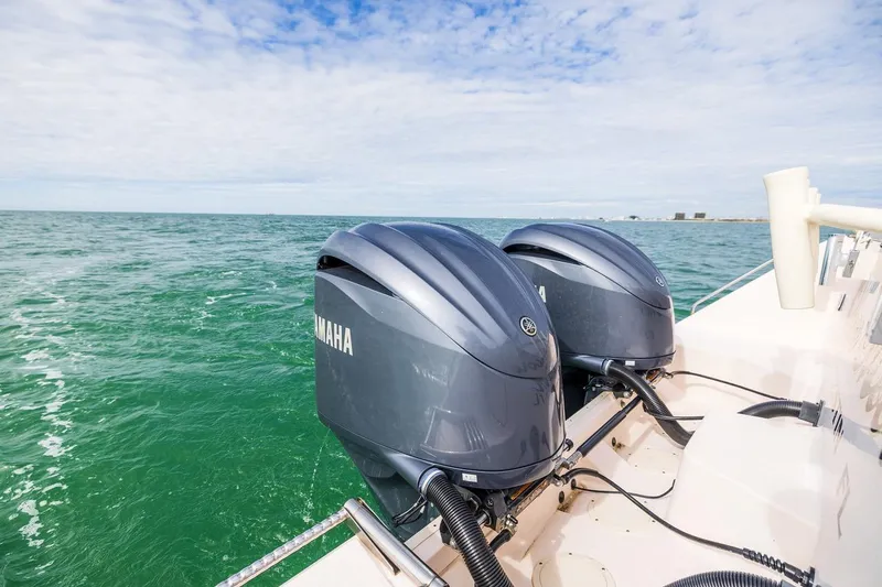 Slide: The Image of 2014 Grady-White Canyon 336 boat with twin Yamaha outboard engines on open water. - 9