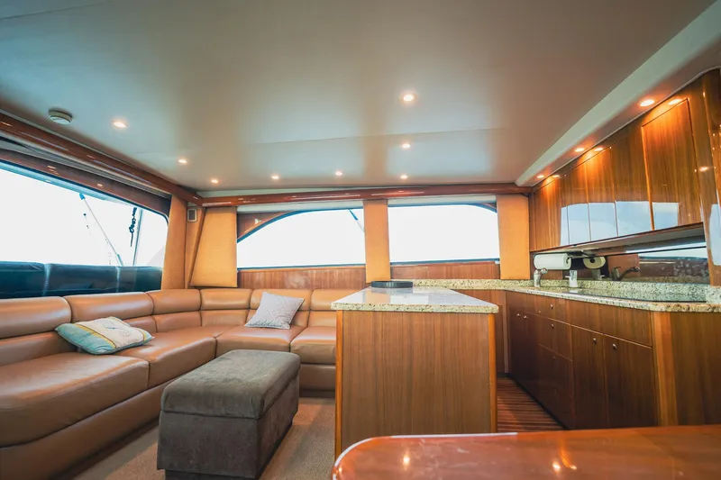 Slide: The Image of Luxurious interior of a 2005 Viking 48 Convertible yacht with plush seating and wood finishes. - 14