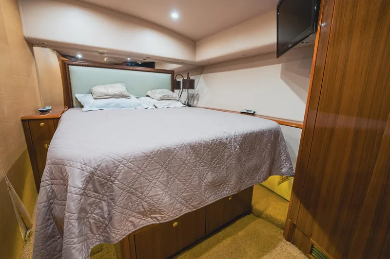 Slide: The Image of Luxurious bedroom interior of 2005 Viking 48 Convertible yacht with cozy bedding. - 22